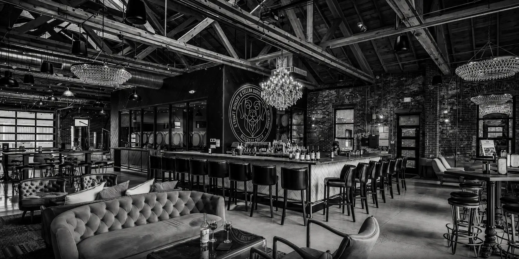 The Bigsby's Folly bar in black and white, chandeliers above the taps