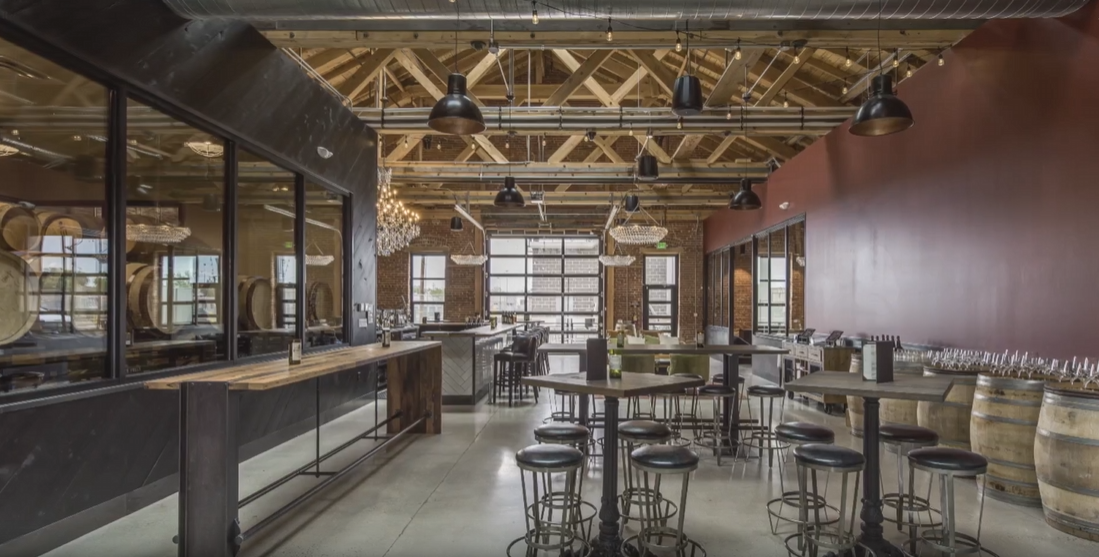 Bigsby's Folly tasting room with timber trusses and leather seating
